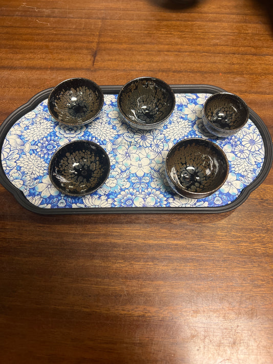 Five small cups with a tea plate